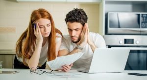 Couple reviewing how to drastically cut their expenses