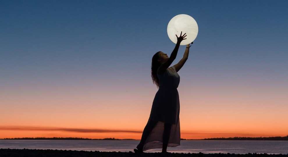 Women reaching for the moon