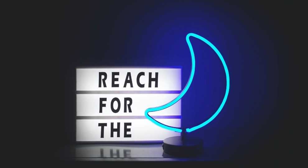 Reach for the moon quote signage